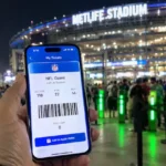 Is SeatGeek legit? A fan holding a mobile ticket outside stadium turnstiles.